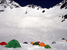 雪に覆われた穂高連峰の麓のテント場