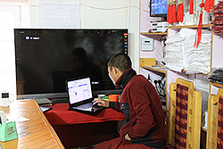 パソコンをする若い僧侶
